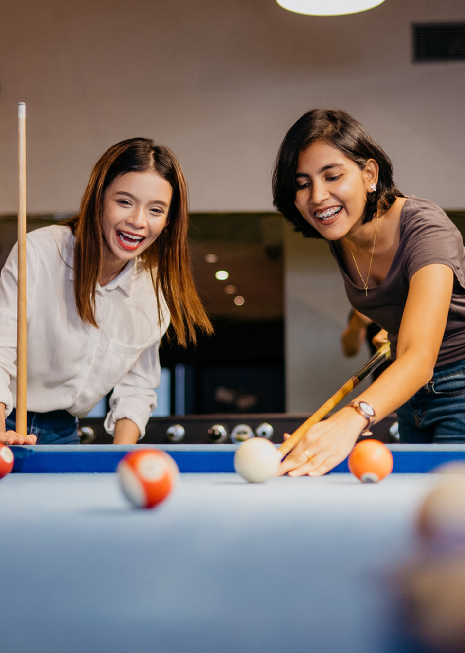 young woman playing pool