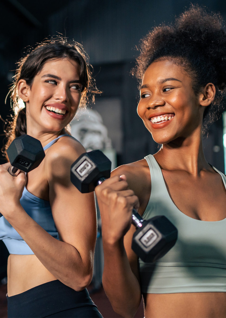 Two young women lifting weights