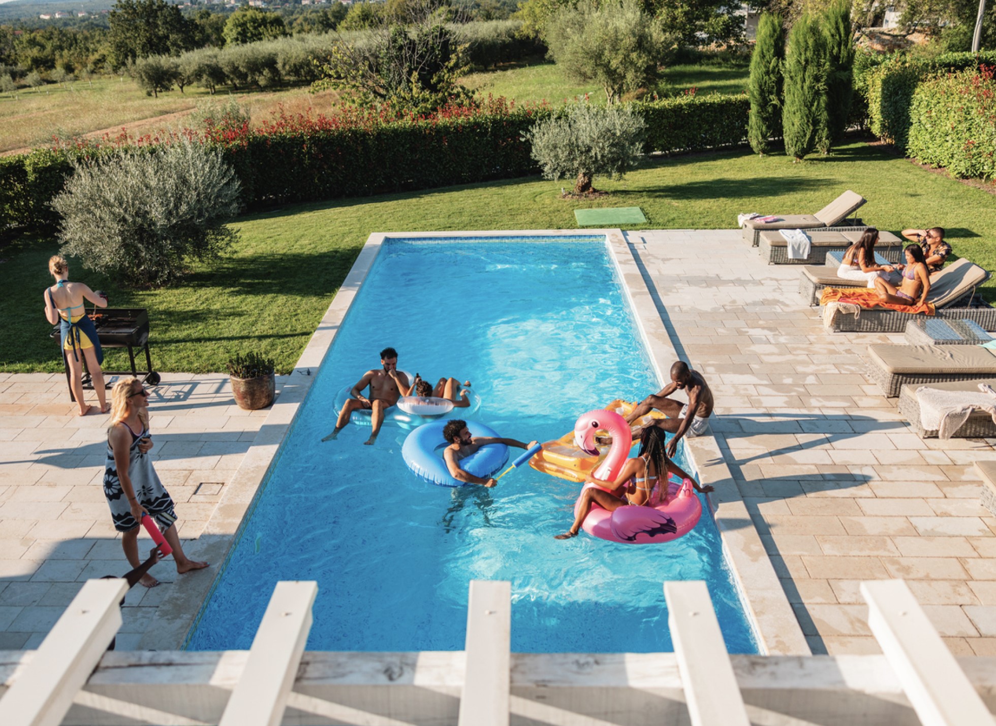 Friends using a swimming pool