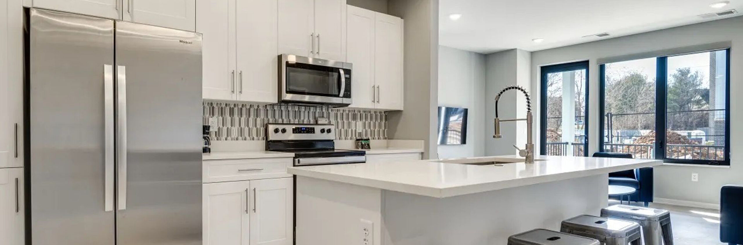 A kitchen with white cabinets