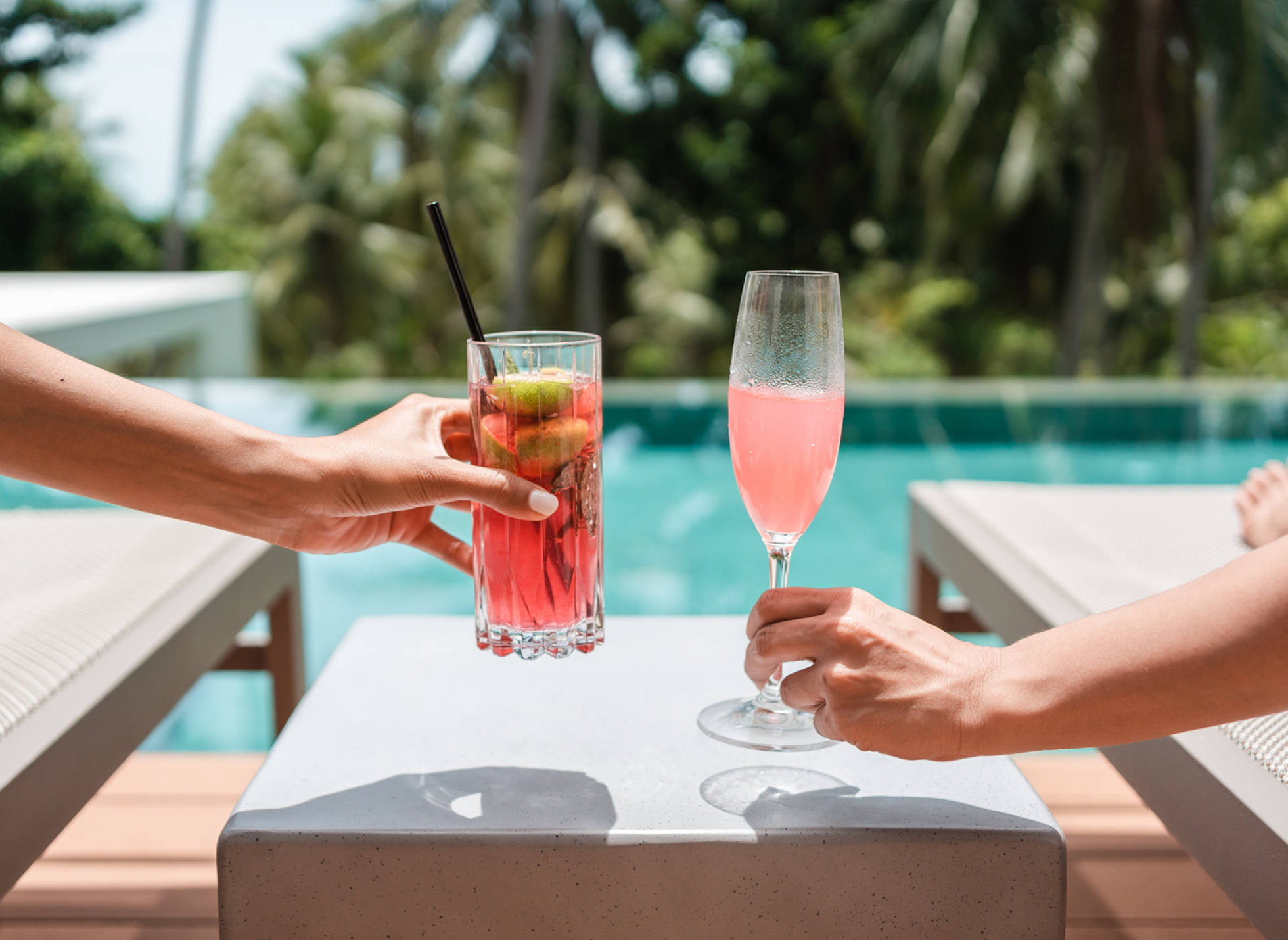 Two drinks by the swimming pool